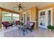 Charming porch features comfortable seating, ceiling fan, and a welcoming atmosphere at 417 Tortuga Dr, Nokomis, FL 34275