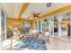 Cozy screened porch offers stylish seating arrangements and serene views, perfect for relaxation at 417 Tortuga Dr, Nokomis, FL 34275