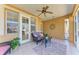 Inviting porch features comfortable seating, a ceiling fan, and stylish decor for outdoor relaxation at 417 Tortuga Dr, Nokomis, FL 34275