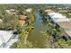 An aerial view of canal-front houses, surrounded by beautiful trees at 417 Tortuga Dr, Nokomis, FL 34275