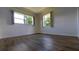 Bright bedroom featuring wood-look floors and large windows at 4328 Webber St, Sarasota, FL 34232