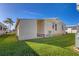 Exterior view of home with green lawn and view of the carport at 4408 13Th E St, Ellenton, FL 34222