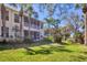 Exterior rear view of a two story home with a large screened in lanai and green lawn at 4480 Cinnamon Dr # 2408, Sarasota, FL 34238