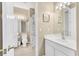 Well-lit bathroom with a shower, toilet, vanity and white cabinets at 4480 Cinnamon Dr # 2408, Sarasota, FL 34238