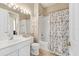 Bright bathroom with a shower and white cabinets at 4480 Cinnamon Dr # 2408, Sarasota, FL 34238