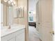 Bright bathroom with white cabinets and a large mirror at 4480 Cinnamon Dr # 2408, Sarasota, FL 34238