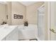 Bright bathroom featuring dual sinks, a soaking tub, and a separate shower at 4480 Cinnamon Dr # 2408, Sarasota, FL 34238