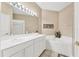 Bright bathroom featuring dual sinks, a soaking tub, and a separate shower at 4480 Cinnamon Dr # 2408, Sarasota, FL 34238