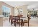 Bright dining room with chandelier and glass table with views to the living room at 4480 Cinnamon Dr # 2408, Sarasota, FL 34238
