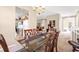 Dining room with six-chair table, chandelier, and adjacent kitchen and living spaces at 4480 Cinnamon Dr # 2408, Sarasota, FL 34238
