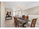 Open floor plan with dining room, chandelier and adjacent console table with decor at 4480 Cinnamon Dr # 2408, Sarasota, FL 34238