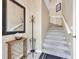 Neutral entryway featuring a staircase, stylish decor, a side table, and gray carpeted stairs at 4480 Cinnamon Dr # 2408, Sarasota, FL 34238