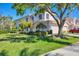 Charming home with manicured lawn, mature tree, and attached two-car garage on a sunny day at 4480 Cinnamon Dr # 2408, Sarasota, FL 34238