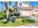 Two-story home featuring a two car garage, terracotta roof, and a well-maintained landscaped yard at 4480 Cinnamon Dr # 2408, Sarasota, FL 34238