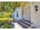 Welcoming front door with brick steps, decorative light fixture and neatly manicured landscaping at 4480 Cinnamon Dr # 2408, Sarasota, FL 34238