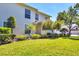 Beautiful two-story home showcasing lush green lawn, well-maintained landscaping, and sunny skies at 4480 Cinnamon Dr # 2408, Sarasota, FL 34238