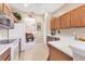 Eat-in kitchen featuring white appliances and countertops with a view into the dining room at 4480 Cinnamon Dr # 2408, Sarasota, FL 34238