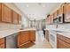 Bright kitchen features tile floors and wooden cabinets, with a view into the living room at 4480 Cinnamon Dr # 2408, Sarasota, FL 34238
