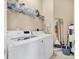 Well-equipped laundry room with modern washer, dryer, and ample shelving at 4480 Cinnamon Dr # 2408, Sarasota, FL 34238