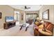 Cozy living room with plush seating, neutral walls, a ceiling fan, and sliding glass doors to a screened patio at 4480 Cinnamon Dr # 2408, Sarasota, FL 34238
