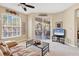 Light-filled living room with comfortable seating and access to a screened porch with outdoor furniture at 4480 Cinnamon Dr # 2408, Sarasota, FL 34238