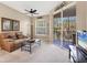 Cozy living room with ceiling fan, decor, and access to the screened porch with seating at 4480 Cinnamon Dr # 2408, Sarasota, FL 34238
