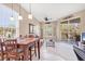 Open floorplan living room features a wood dining table and a sliding glass door to the porch at 4480 Cinnamon Dr # 2408, Sarasota, FL 34238