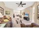 Spacious living room with plush seating, a TV, a ceiling fan, and neutral wall paint at 4480 Cinnamon Dr # 2408, Sarasota, FL 34238