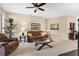 Comfortable living room with neutral walls, plush carpeting, a ceiling fan, and glass coffee table at 4480 Cinnamon Dr # 2408, Sarasota, FL 34238