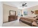 Comfortable main bedroom with ceiling fan and view of backyard at 4480 Cinnamon Dr # 2408, Sarasota, FL 34238