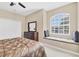 Comfortable main bedroom with ceiling fan and window seating area at 4480 Cinnamon Dr # 2408, Sarasota, FL 34238
