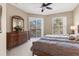 Comfortable main bedroom with ceiling fan and access to outdoor balcony at 4480 Cinnamon Dr # 2408, Sarasota, FL 34238