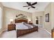 Comfortable main bedroom with ceiling fan and sliding closet door at 4480 Cinnamon Dr # 2408, Sarasota, FL 34238