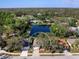 Top-down aerial view shows the property's location near a pond and among lush greenery at 4627 Breezy Pines Blvd, Sarasota, FL 34232