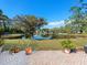 The backyard features a view of the pond and brick pavers at 4627 Breezy Pines Blvd, Sarasota, FL 34232
