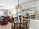 Dining room with glass table and mirrored wall that reflects into the kitchen at 4627 Breezy Pines Blvd, Sarasota, FL 34232