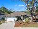 Charming single-story home featuring a well-manicured lawn, a two-car garage, and a welcoming front entrance at 4627 Breezy Pines Blvd, Sarasota, FL 34232