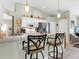 Open kitchen with bar seating, white cabinetry, and stainless steel appliances at 4627 Breezy Pines Blvd, Sarasota, FL 34232
