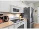 Kitchen with white cabinetry, stainless steel refrigerator and oven at 4627 Breezy Pines Blvd, Sarasota, FL 34232