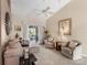 Cozy living room with vaulted ceiling, neutral color palette, comfortable seating, and sliding glass doors to patio at 4627 Breezy Pines Blvd, Sarasota, FL 34232