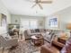 Relaxing living room showcasing a large sectional sofa, ceiling fan, and plenty of natural light at 4627 Breezy Pines Blvd, Sarasota, FL 34232