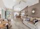 Inviting living room featuring plush seating, neutral tones, and an abundance of natural light at 4627 Breezy Pines Blvd, Sarasota, FL 34232