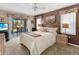 Serene main bedroom with a king-sized bed and sliding glass doors to a screened lanai at 4627 Breezy Pines Blvd, Sarasota, FL 34232