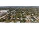 An aerial view of a quiet, lush residential neighborhood with tree-lined streets and well-maintained homes at 4711 Placid Cir, Sarasota, FL 34231