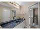Functional bathroom features a blue countertop vanity, a large mirror, and shower at 4711 Placid Cir, Sarasota, FL 34231