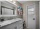 Well-lit bathroom showcases a marble countertop vanity and decorative wallpaper for an elegant touch at 4711 Placid Cir, Sarasota, FL 34231