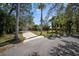 Beautiful single-story home with a long driveway and lush tropical landscaping at 4711 Placid Cir, Sarasota, FL 34231