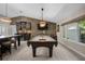 Entertaining game room featuring a pool table, bar, and stylish stone accent wall for a fun atmosphere at 4711 Placid Cir, Sarasota, FL 34231