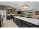 Stylish game room with a bar, pool table, island seating, and stone accent wall perfect for entertaining at 4711 Placid Cir, Sarasota, FL 34231