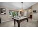 Spacious game room featuring a pool table, window, and casual decor at 4711 Placid Cir, Sarasota, FL 34231